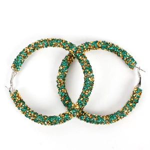 Detail of large hoop earrings with emerald green and champagne gold pavé rhinestones