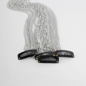 Detailed view of silver tassel hair chains with black BB clips on white background