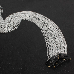 Detail of silver tassel hair chains attached to three black metal BB clips for wigs