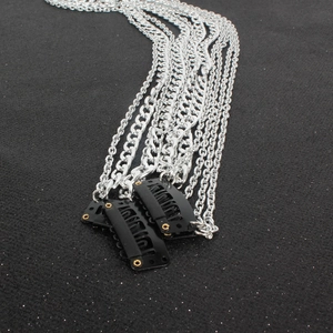 Detail of multi-layered silver plated chains with black snap clips for punk hair styling