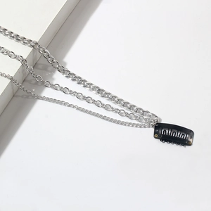 Close-up of layered silver fringe hair chains with secure black snap clips for styling