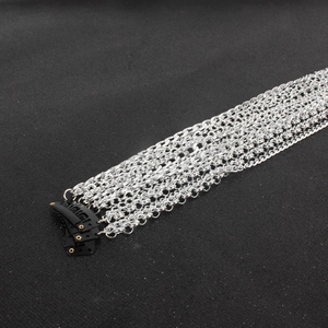 Detail showing multi-layer silver tassel hair chains with black BB clips for styling