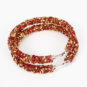 Fashionable hoop earrings with red and gold pavé crystals on a minimalist silver frame