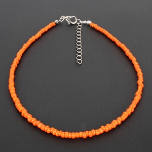 Detail of bright orange seed bead choker with adjustable silver lobster clasp closure