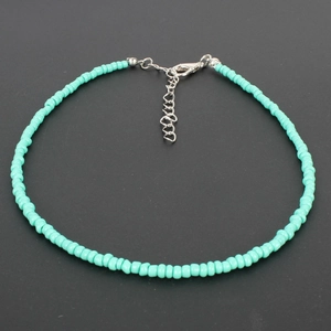 Detail of turquoise beaded choker necklace featuring silver lobster clasp and extension chain