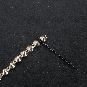 Punk style black hair clip featuring rows of polished silver metal cone studs