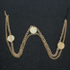 Gold multi-layered body chain with coin pendants and embossed relief on black background
