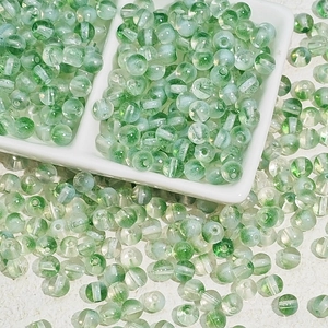 Gros plan de perles de verre vert clair translucides pour bijoux DIY et colliers