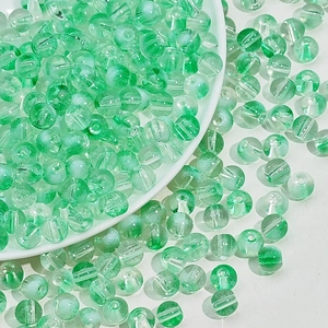 Détail macro de perles en verre vert clair translucide avec texture craquelée