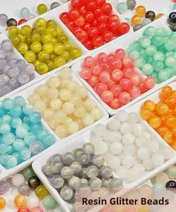 Detalle macro de cuentas de resina brillantes de 8-10mm en una bandeja divisoria