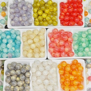 Colorful cat-eye resin beads for DIY jewelry making in a white ceramic sorting tray