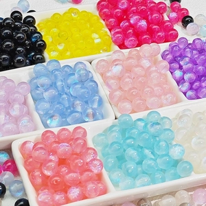 Colorful aurora resin beads collection in white divider box for DIY jewelry making