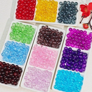 Macro shot of colorful 8mm transparent glass beads for DIY jewelry making in a divider tray