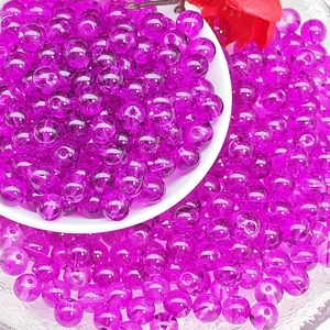 Macro shot of 8mm translucent purple glass beads in a ceramic dish for DIY jewelry making