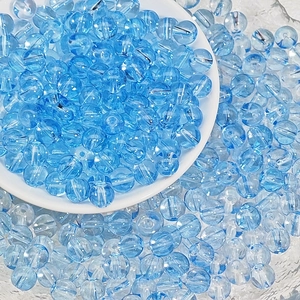 Macro shot of 8mm transparent light blue glass beads for DIY jewelry making and crafts