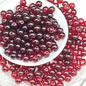 Macro shot of deep red 8mm round glass beads for handmade jewelry DIY projects