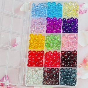 Detail of 15-compartment organizer box with multi-colored 8mm glass beads for DIY jewelry