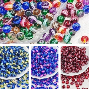 Macro view of assorted crackle glass beads in multiple colors for DIY jewelry making