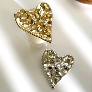 Vintage irregular gold and silver pleated heart brooches with a polished mirror finish