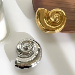 Minimalist streamline conch shell brooch in polished gold and silver finishes