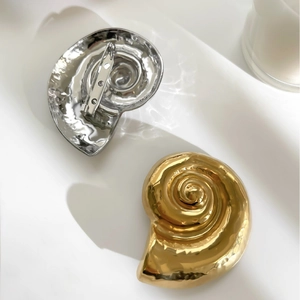 Minimalist snail shell brooch in gold and silver finish with hammered metal texture