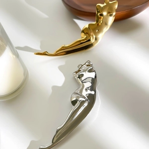 Minimalist body sculpture brooch in gold and silver polished stainless steel finish