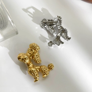 Fashionable poodle dog brooches in gold and silver finishes with realistic curly texture
