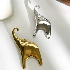 Elegant elephant brooch jewelry in gold and silver finish with polished mirror surface