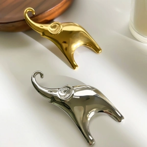Polished gold and silver elephant brooch pins for women with sleek minimalist design