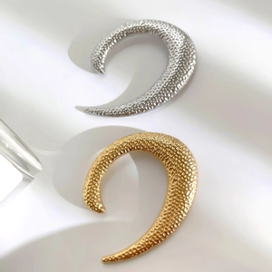U-shaped stainless steel brooches in gold and silver with textured hammered finish