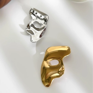 Abstract portrait mask brooch in gold and silver finish with polished stainless steel texture