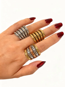 Close-up of polished multi-layer wave texture rings in gold and silver finishes