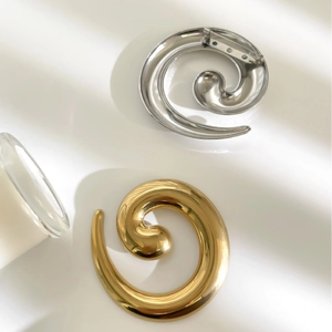 Polished spiral twisted metal snail brooch in gold and silver finish with secure pin back