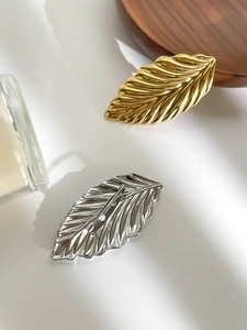 Detail of leaf brooches in gold and silver finish with realistic texture and pin backing