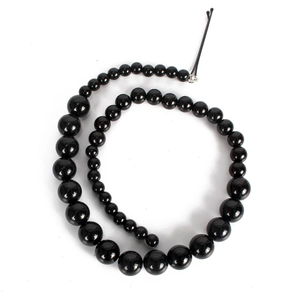 Chic black imitation pearl hair chain with gradient bead sizes on white background