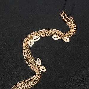 Bohemian gold layered hair chain with metallic tassels, white shells and elastic band