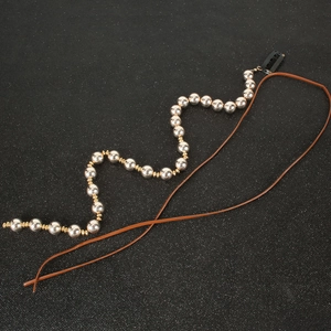 Silver beaded chain hair accessory with brown leather cords and black snap clip for women