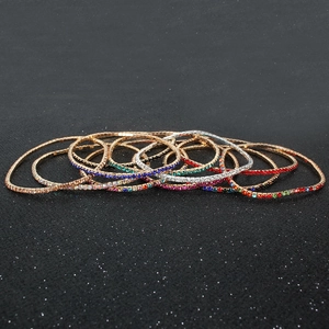 Close-up of colorful rhinestone stretch bracelets in gold and silver metal settings