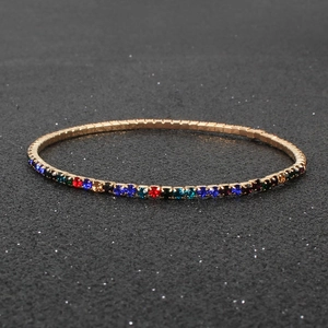 Elegant gold bracelet with minimalist colorful rhinestones in a slender rainbow design