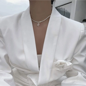 Elegant silver-tone tennis chain necklace with a sparkling diamond-set capital letter R