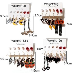 Halloween earring set with pumpkin ghost and bat designs on white background