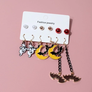 Detailed view of Halloween earring set with ghost, bat, and moon charms on card