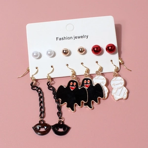 Detail of Halloween earring set featuring pumpkin, ghost, and mummy charms on card