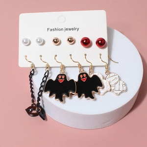 Close-up of Halloween earring set featuring ghost, mummy and lip charms on display card
