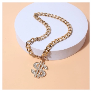 Golden Cuban dog chain with rhinestone dollar sign pendant on a white platform