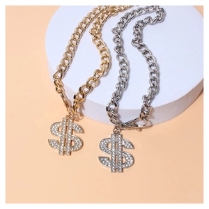 Close-up of gold and silver cuban link pet necklaces with rhinestone dollar sign pendants