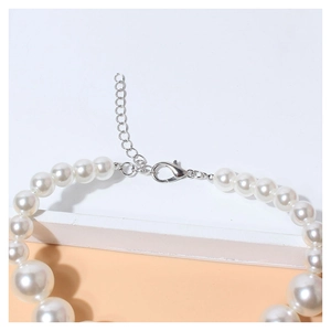 Detail of pet pearl necklace showing adjustable silver lobster clasp and extension chain