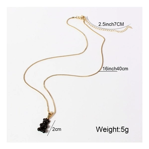 Vintage gold chain necklace with black gummy bear pendant showing product dimensions