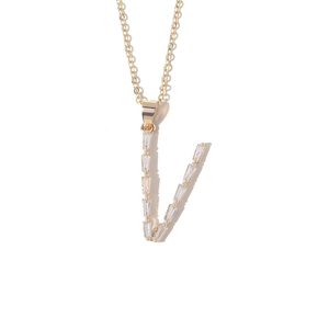 Macro view of gold plated V letter pendant featuring rectangular cubic zirconia stones