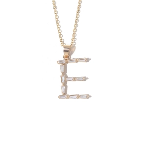 Close-up of gold plated letter E pendant necklace with baguette cut cubic zirconia
